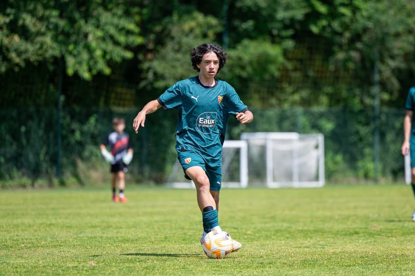 A young player driving the ball at the academy