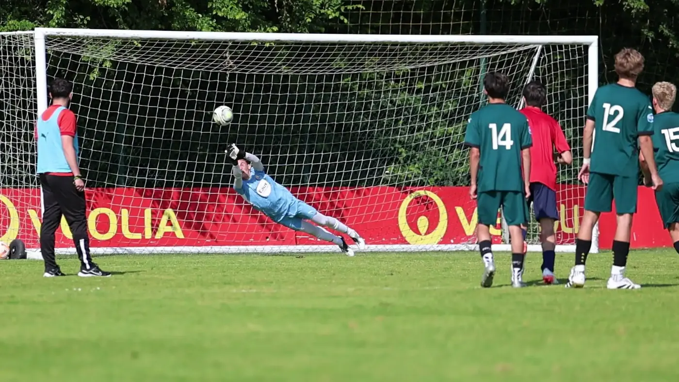 A goalkeeper diving to make a save